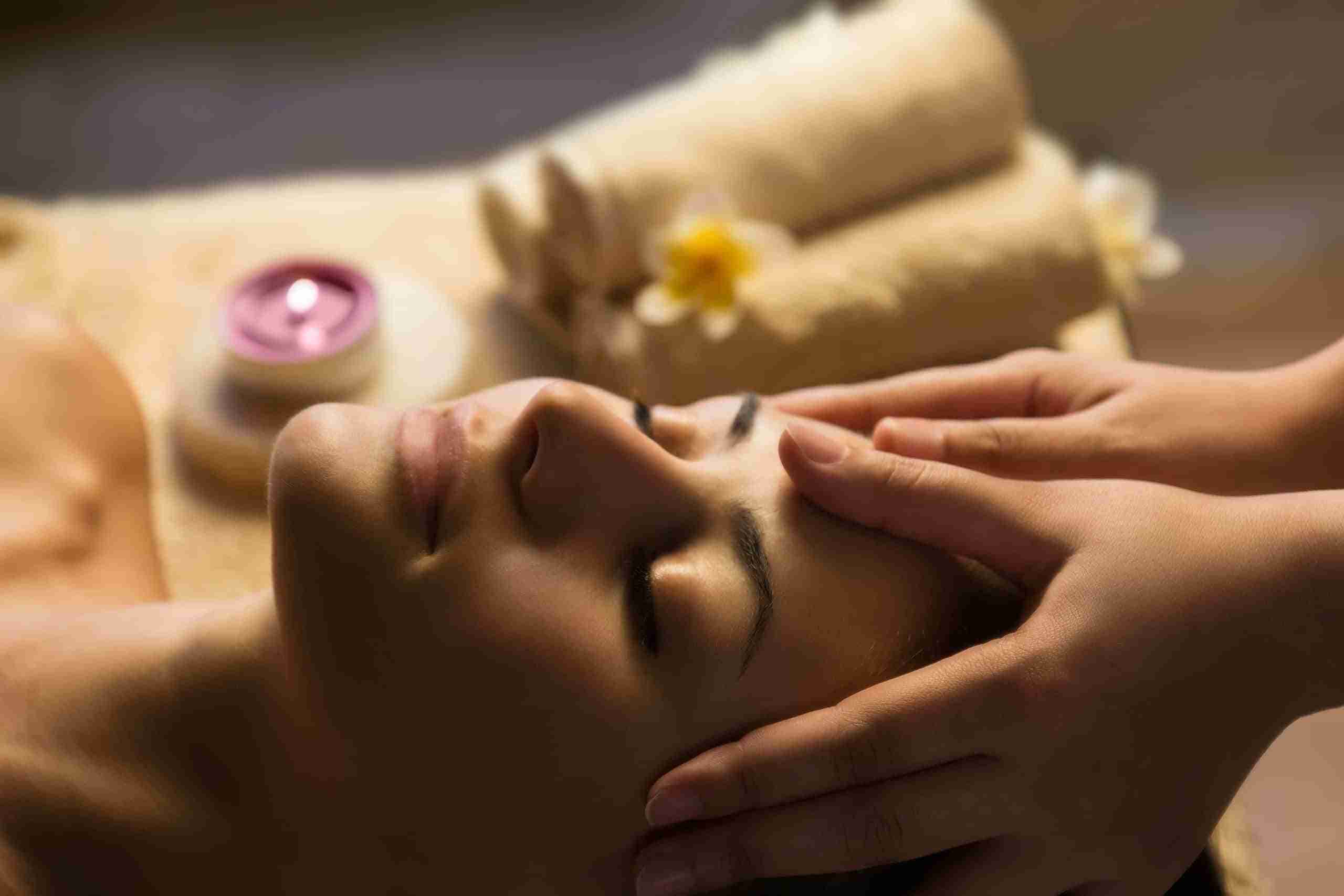During Reiki.  Woman lying peacefully in a spa receiving reiki