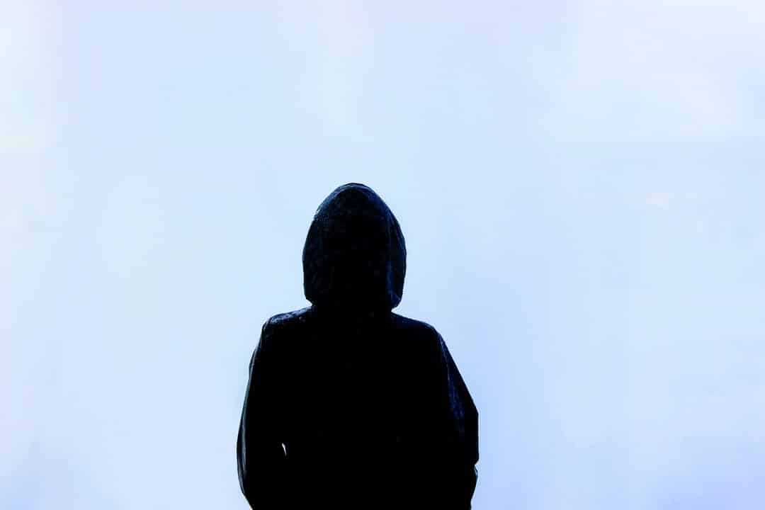 Before Reiki.  Person with a black hoodie looking out into nothingness
