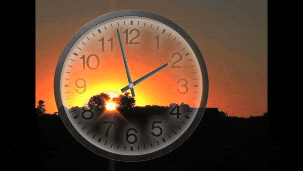 Clock's time being reset as it moves back in time with the image of sunset in the background